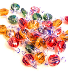Cherry flavor candy pieces in glossy ruby red.