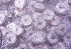 DM Sweets Orange Mints angled bulk view, easy to portion in bowls or baskets.