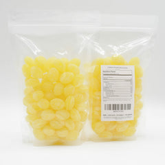 Donty-Tonty Sanded Lemon Drops bulk dispensing jar on a countertop for quick portions.