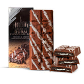 Dubai Choco Cookies & Cream bar unwrapped, rich chocolate with kataifi crunch for dessert indulgence.