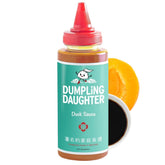 Dumpling Daughter duck sauce bottle being poured, ideal for dipping.