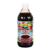 Dynamic Health Tart Cherry Juice Concentrate bottle on kitchen counter, unsweetened and ideal for smoothies.