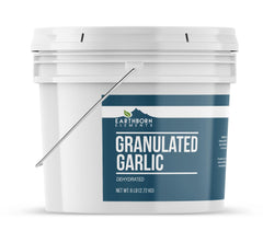 Earthborn Elements granulated garlic being measured for a recipe, precision seasoning.