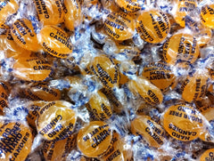 Emporium sugar-free butterscotch buttons displayed in a dish for sharing.