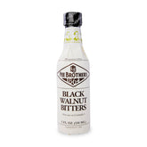 Fee Brothers Black Walnut bitters bottle being poured for cocktails.