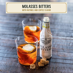 Fee Brothers Molasses Bitters being poured into a glass to deepen a drink.