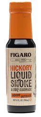 Figaro Hickory Liquid Smoke bottle being used to flavor steak indoors.