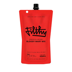 Filthy Food Bloody Mary Mix pouch on a bar counter, ready for restaurant-quality cocktails at home.