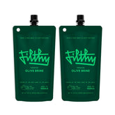 Filthy Food olive brine bottle pour showing bar-quality martini base