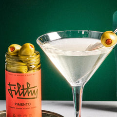 Olives inside the Filthy Food jar showing hand-stuffed pimento filling