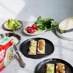 Finn Crisp Multigrain Crispbread on a charcuterie board, pairing with meats and spreads.