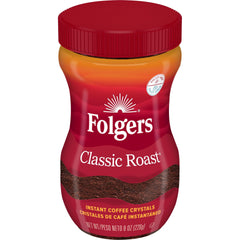 Folgers Classic Roast Instant Coffee jar on a kitchen counter for quick brewing.