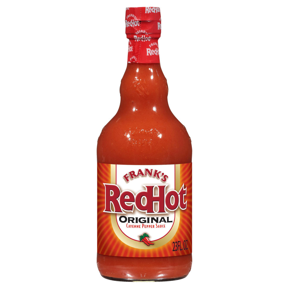 Frank's RedHot Original bottle being poured to add heat and flavor to wings