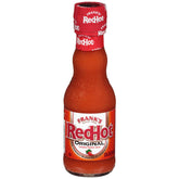 Frank's RedHot Original bottle pouring heat for wings and more