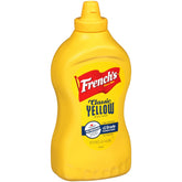 French's Classic Yellow Mustard bottle on table, ready to top sandwiches.