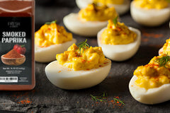 Fresh Finest smoked paprika being sprinkled to add color and depth.