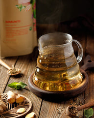 Gardenika Organic Immune Tea brewing setup with infuser and cup
