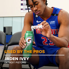 Athlete using a bottle with a dissolving tablet during practice.