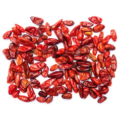Close-up of dried pequin peppers highlighting their citrusy, smoky aroma.