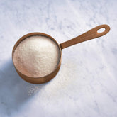 Ghirardelli Sweet Ground White Chocolate Beverage Mix package ready for espresso and milk.