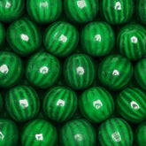 Global Gumball watermelon gumballs in a vending machine, delivering bright color and fruity flavor.