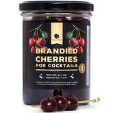 Gourmanity brandied cherries in Kirsch bottle highlight premium cocktail garnish.