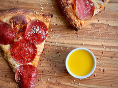Grandioso garlic sauce paired with pizza and breadsticks for a savory dip.