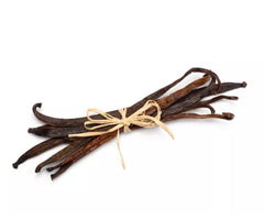 Split Green Vanilla beans exposing rich seeds for flavoring.