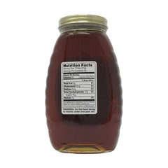 Gunter's Wildflower honey closeup showing dark color and molasses finish.