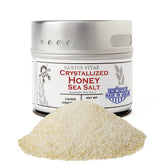 Gustus Vitae crystallized honey sea salt tin on countertop, ideal finishing touch for dishes.