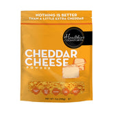 Healthier Comforts cheddar cheese powder 7oz bag shows resealable packaging for freshness.