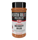 Hea th Riles Honey Rub bottle with golden glaze enhances grilled meat flavor