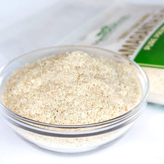 Pouring HerbaZest Amaranth Flakes into a smoothie for added protein and fiber.