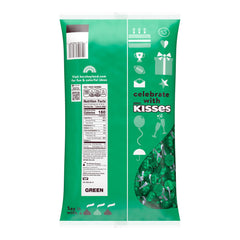 HERSHEY'S KISSES milk chocolate closeup with green foil wrap for celebrations.