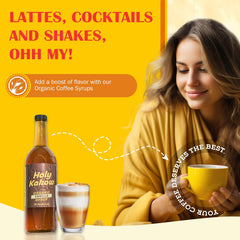 Holy Kakow Vanilla Syrup bottle with label on counter, emphasizing organic sourcing.