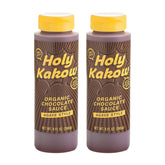 Holy Kakow Organic Chocolate Sauce bottle pouring over dessert for rich, gluten-free indulgence