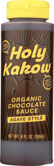 Holy Kakow Organic Chocolate Sauce bottle on the counter, perfect dessert topping.
