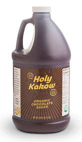 Holy Kakow Organic Chocolate Syrup bottle ready for rich drizzle over ice cream.