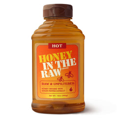 IN THE RAW Hot Honey bottle pouring, perfect for a sweet heat drizzle on pizza and cheese boards.