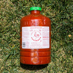 Huy Fong Sriracha chili closeup highlighting fresh jalapeño peppers