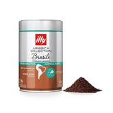 illy Arabica Brasile ground coffee, close-up ready for home brewing with a smooth, balanced cup.