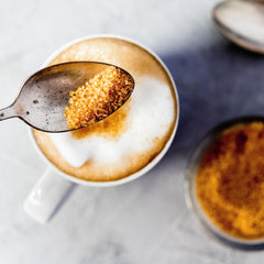 India Tree Demerara sugar dissolving in a hot coffee cup for layered sweetness
