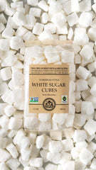 India Tree white sugar cubes beside a tea setup, emphasizing versatile use.