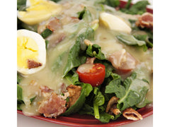 Jake & Amos Real Bacon Dressing drizzled on a crisp salad