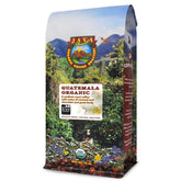 Java Planet Low Acid Coffee bag with label and ready-to-grind whole beans.