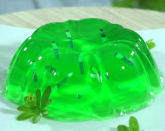 Stirring Jell-O lime sugar-free gelatin with cold water for a smooth set.
