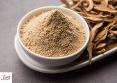 Pouring Jiva Organics amchur powder into a dish to show versatility
