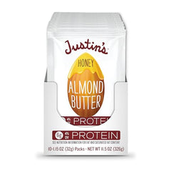 Justin's Honey Almond Butter Squeeze packs on table showcasing variety for tasting during adventures