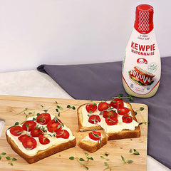 Kewpie mayo bottle in action pouring for even coating.