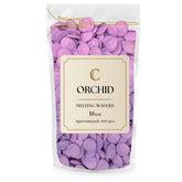 KIDU Merckens chocolate melting wafers in orchid color for dipping and glossy coatings.